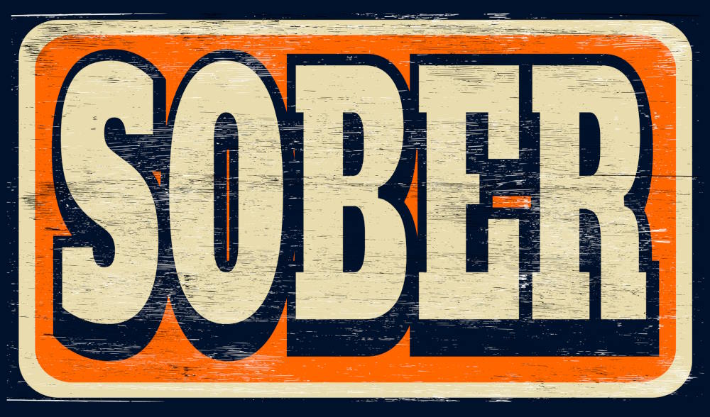Image of a wooden plaque the word "sober" on it