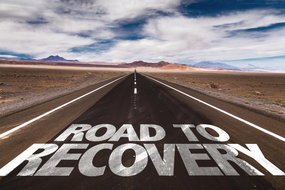 Image of a highway with the words "road to recovery" written on
