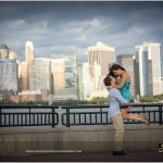 Tom holding up Denise at the Liberts State Park in NJ with New York in the backdrop