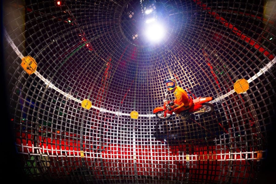 Image of a Do Portugal Circus motorcyclist inside of the globe of death